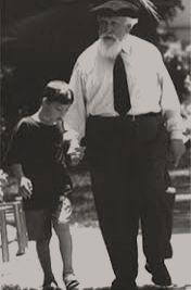 Professor Feuerstein walking hand in hand with a young boy